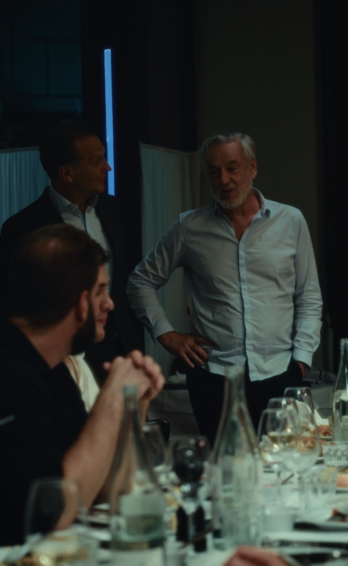 A guest addressing the table at a private dinner